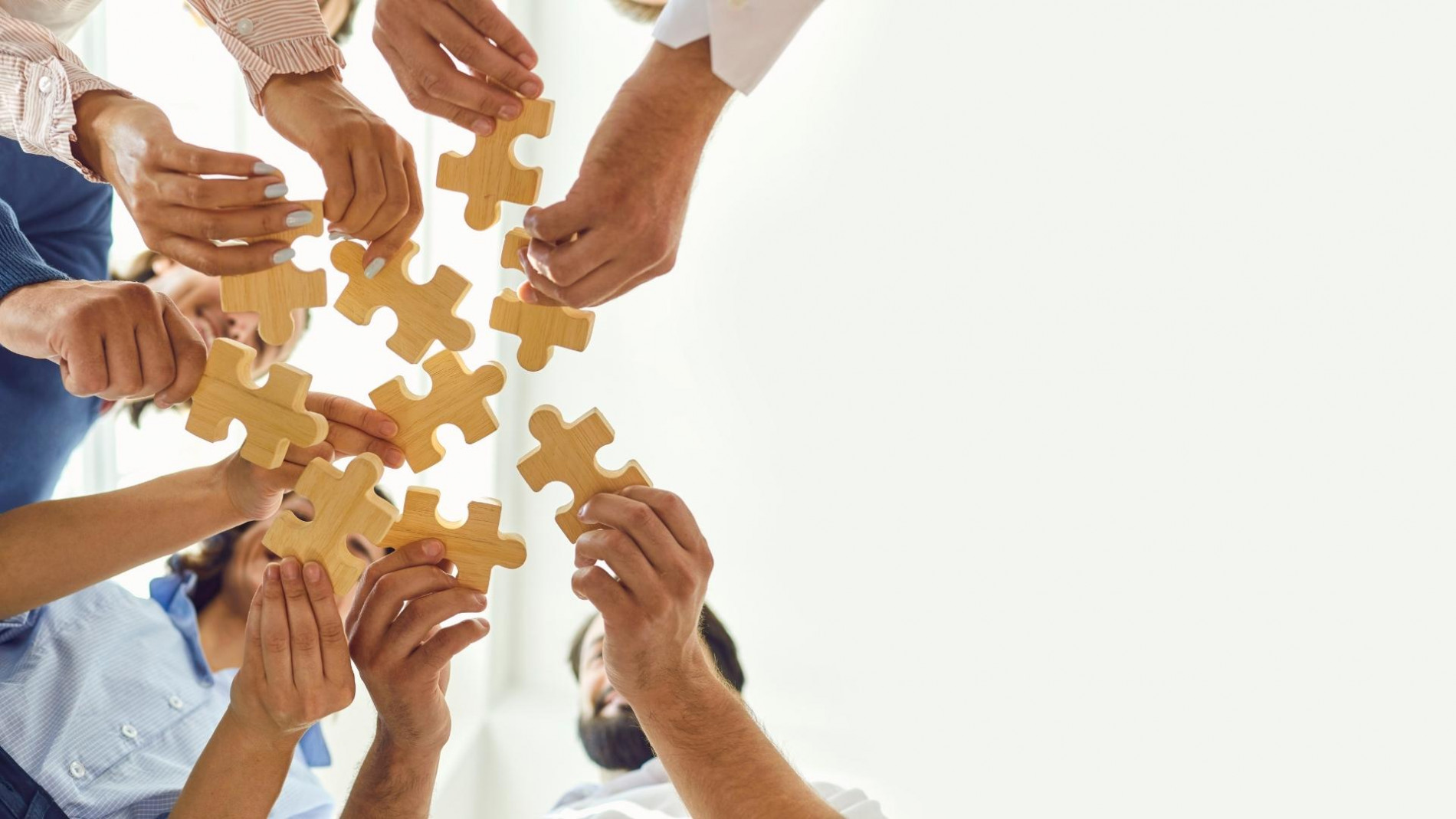 A group of people holding puzzles in their hands